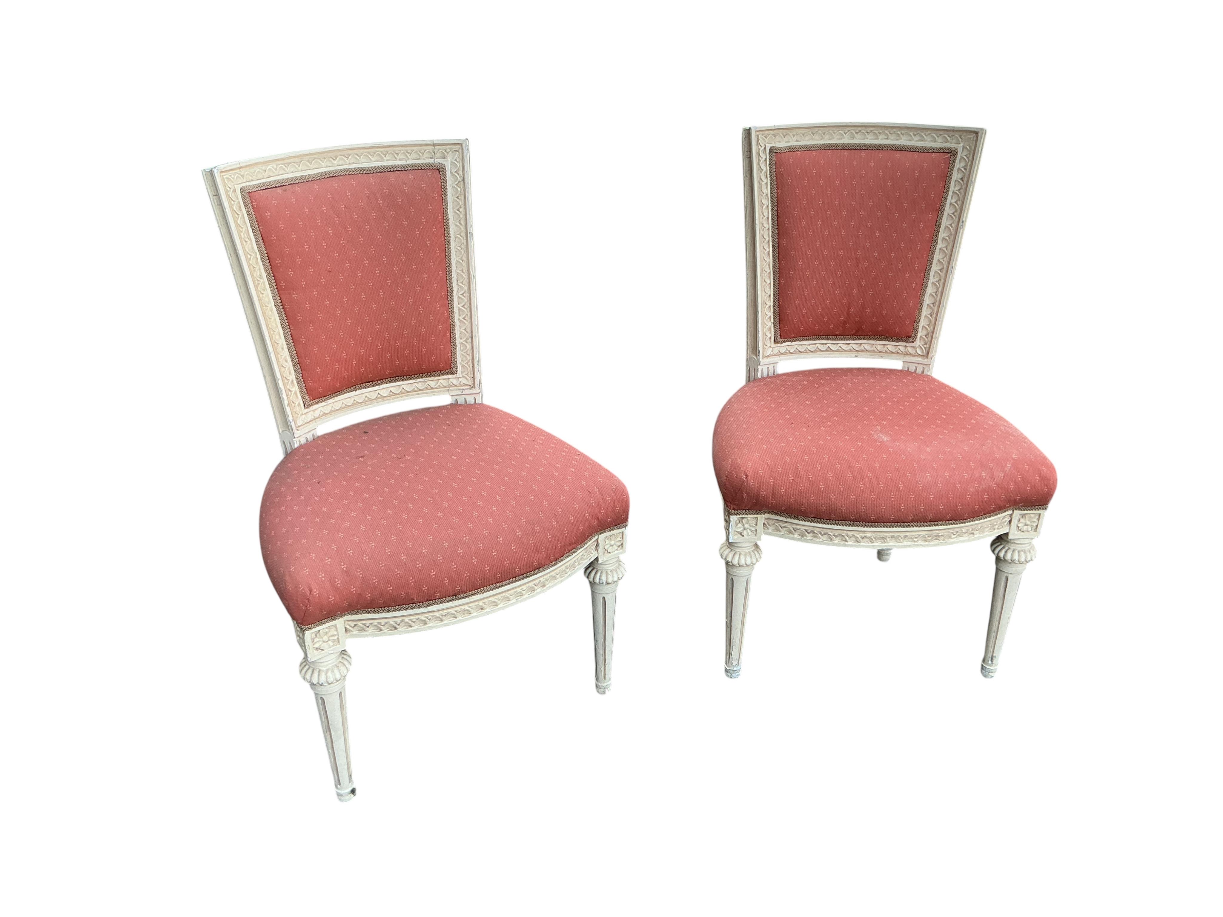 A harlequin set of six 20th century Louis XVI style white painted chairs with red upholstery